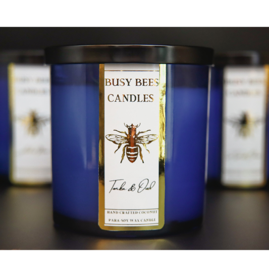 Blue candle jar gold label with busy bees candles shop bee label from busybeescandles.shop the fragrance Tonka & Oud